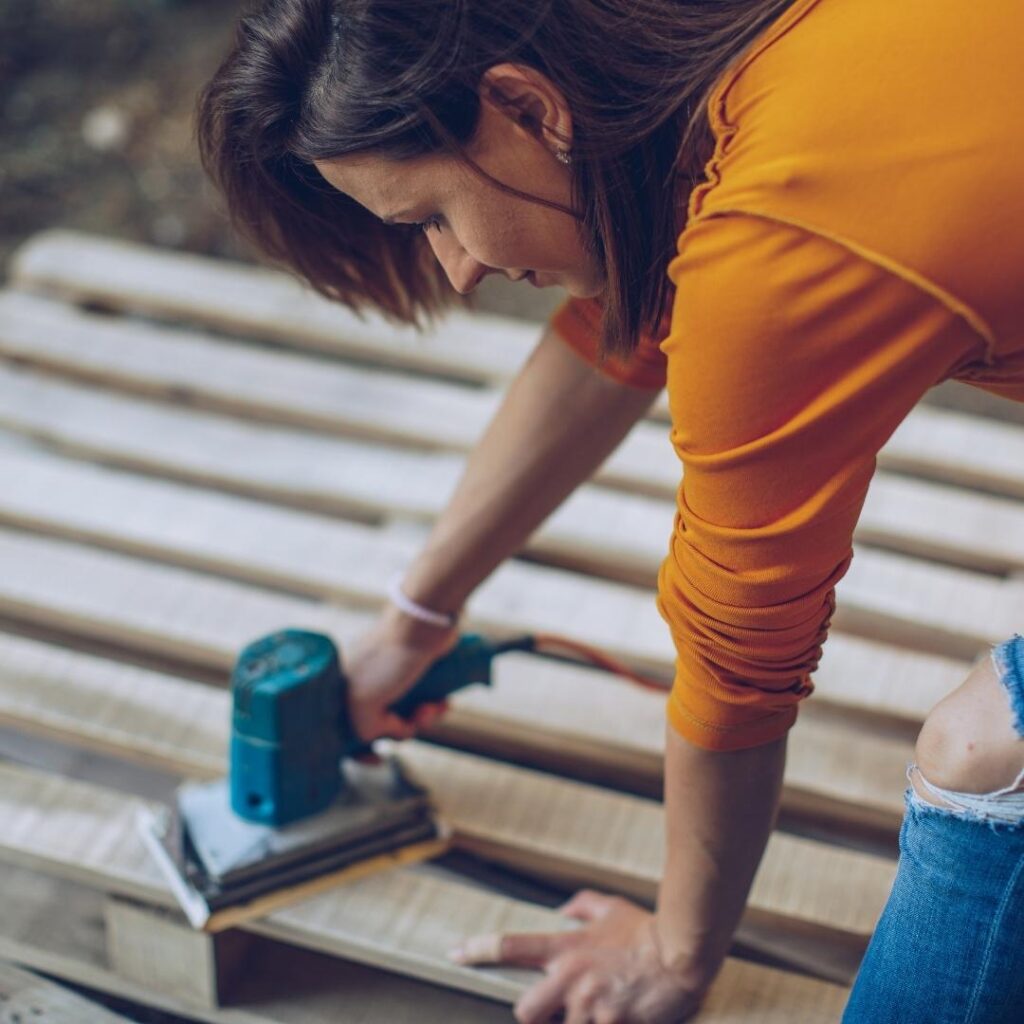2 Set a Budget Woman working on a DIY project with found materials