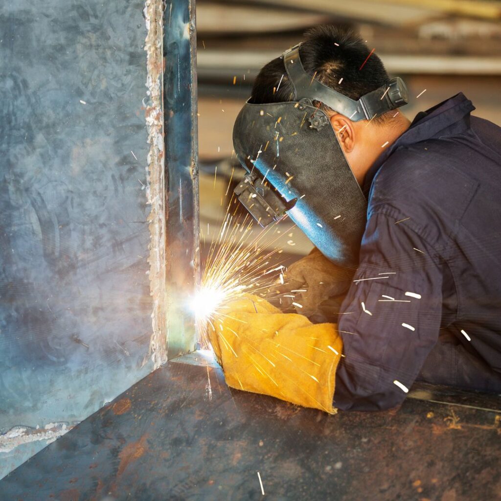 welder wearing a mask while working