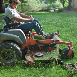 Person on a zero-turn riding mower