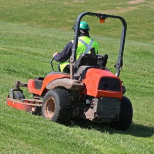 Person on a zero-turn riding mower